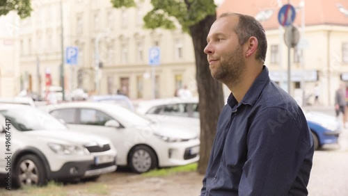 Wallpaper Mural A Caucasian man looks around in an urban area - a colorful street and cars in the blurry background Torontodigital.ca