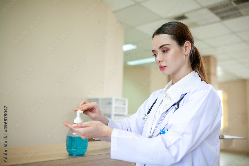Woman doctor using hand sanitizer.