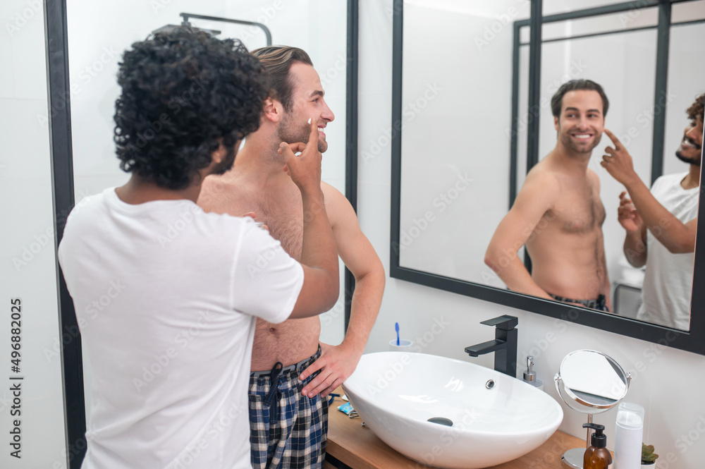 Caring guy preparing his boyfriend for a shave Caring guy preparing his boyfriend for a shave