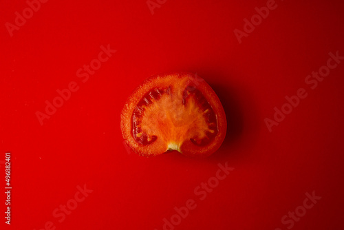 Red tomato on a red background © Tetiana Romaniuk