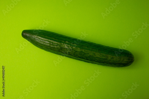 Green cucumber on a green background