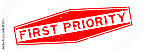 Grunge red first priority word hexagon rubber seal stamp on white background