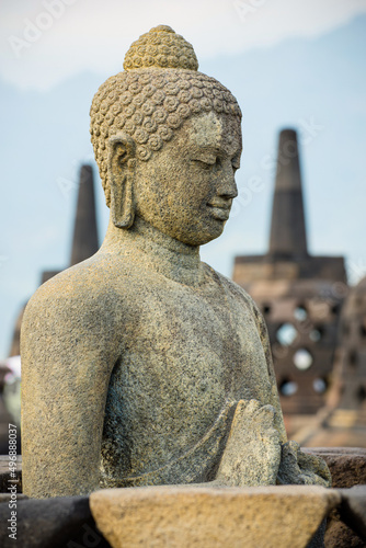 Side portrait of buddha statue at buddhist temple Borobudur, Java, Indonesia