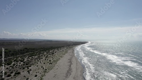 video with drone a few meters from the sea on the beach of spille, the coast of albania, frontal plane with ascent. photo