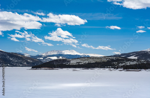 Colorado mountain views over frozen Dillon Lake Reservoir on a bright spring day near Frisco.