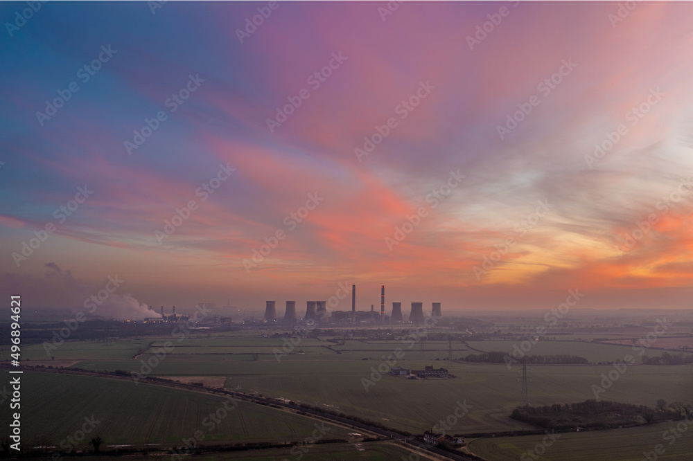 Fototapeta premium Landscape view of coal fired power station at sunset