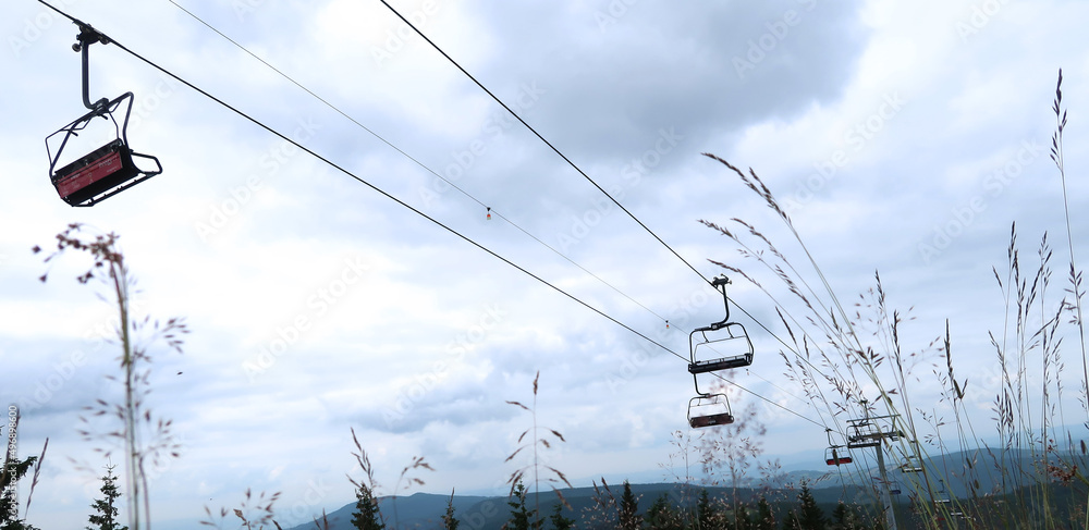 Cableway captured from the ground as a dark silhouette against the blue sky. Giant Mountains (Krkonose), Czech Republic, Bohemian Region.