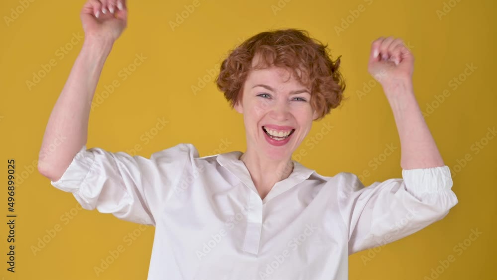 Positive young girl posing isolated on yellow studio background. women looking camera shocked surprised say wow. People emotions lifestyle concept. Positive young girl posing isolated on yellow studio background. women looking camera shocked surprised say wow. People emotions lifestyle concept.