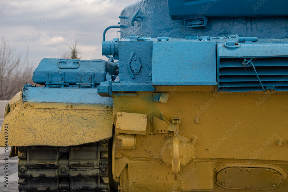 Piece of military vehicle painted in Ukrainian national colors. 