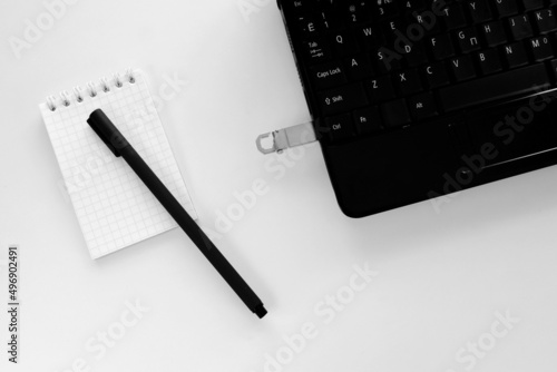 Technology concept of notepad and pen  laptop and flash drive