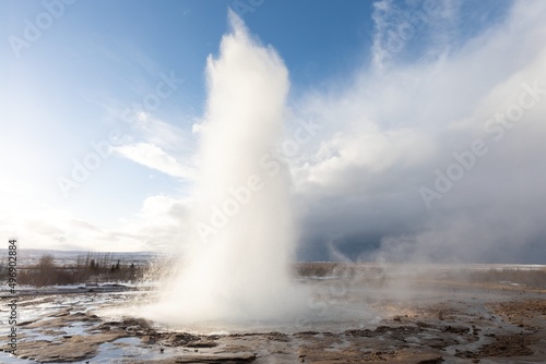 Strokkur Geysir Geyser in southwest Iceland. The famous tourist attraction Geysir on route 35 at sunrise. High eruption of boiling water in the Haukadalur geothermal area. Water fountain in winter.