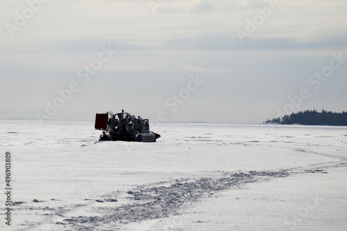 snowmobile on the ice of the frozen lake in sunny day