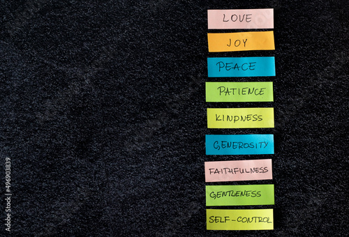 Canvas Print Colorful list of the fruits of the Holy Spirit (love, joy, peace, patience, kindness) isolated on dark background with copy space