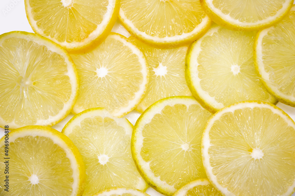 Juicy yellow lemon cut into round slices. Fruit background, top view. Vitamins and ingredients for a refreshing summer lemonade.