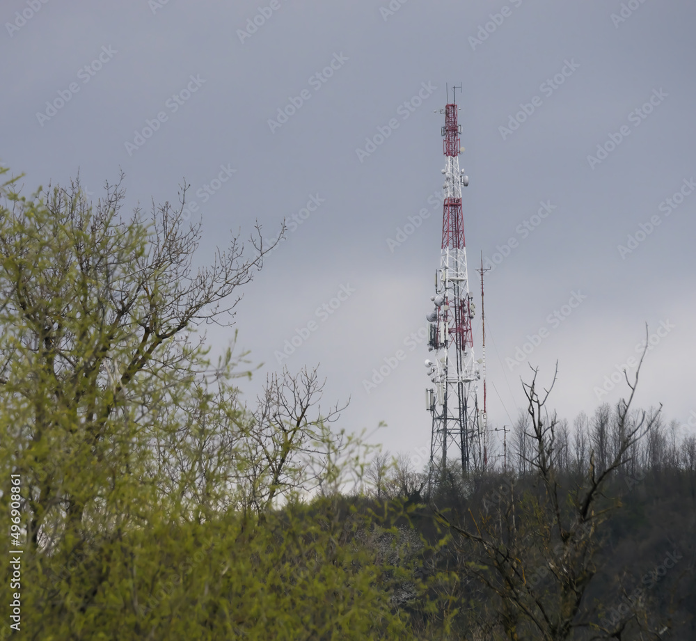 Communication tower on top of the hill with the sky in the background
