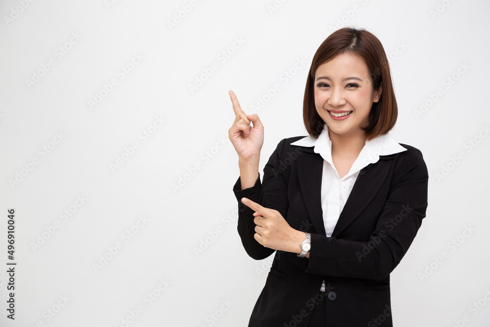 Young Asian businesswoman in black suit pointing to empty copy space isolated on white background Young Asian businesswoman in black suit pointing to empty copy space isolated on white background