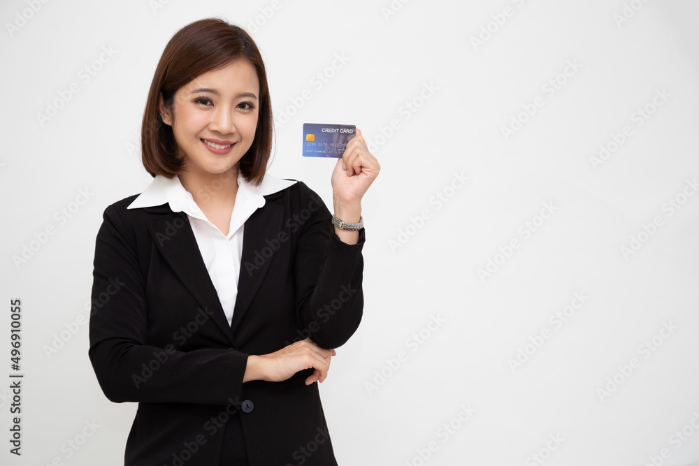 Young beautiful Asian business woman wearing black suit smiling, showing, presenting credit card for paying online business isolated on white background Young beautiful Asian business woman wearing black suit smiling, showing, presenting credit card for paying online business isolated on white background