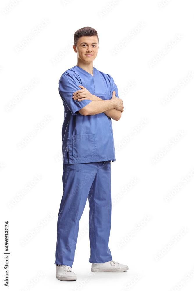 Full length shot of a young male intern worker in a blue uniform posing with crossed arms - obrazy, fototapety, plakaty 