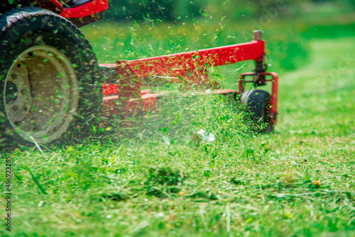 lawnmover at work in a meadow	