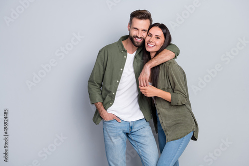 Portrait of attractive tender gentle cheerful couple life partners cuddling romance isolated over grey pastel color background photo