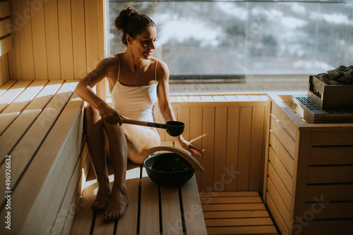 Young woman pouring water o...