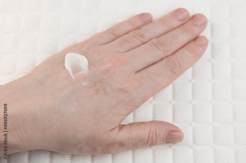 Women's hands applying cream. The concept of skin care. Women's hands applying cream. The concept of skin care.