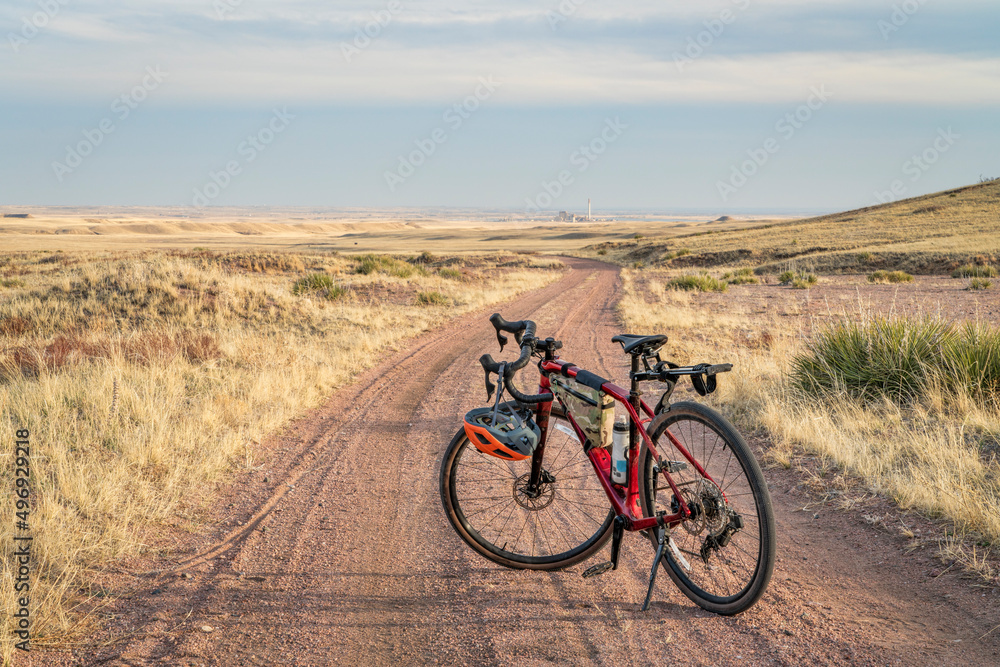 gravel bike on a dirt road in Colorado prairie - Sand Wash trail in Soapstone Prairie Natural Area near Fort Collins, Colorado gravel bike on a dirt road in Colorado prairie - Sand Wash trail in Soapstone Prairie Natural Area near Fort Collins, Colorado