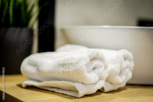 Beautifully folded white towels and toiletries. Modern hotel bathroom © Viesturs