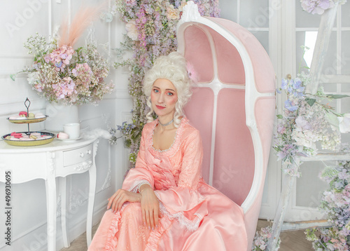 Young pretty woman closeup in pink royal dress. Marie Antoinette cosplay