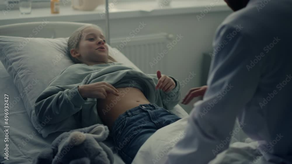 Physician visit patient ward after therapy. Cute girl lying in hospital bed. Physician visit patient ward after therapy. Cute girl lying in hospital bed.