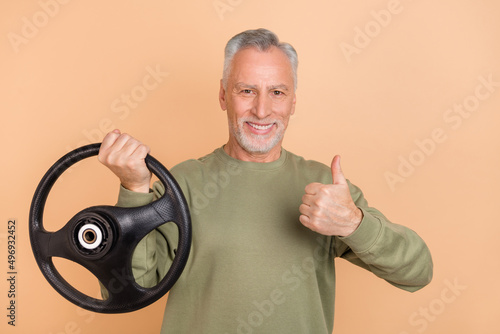 Photo of hooray old grey hairdo man thumb up drive wear green pullover isolated on beige color background