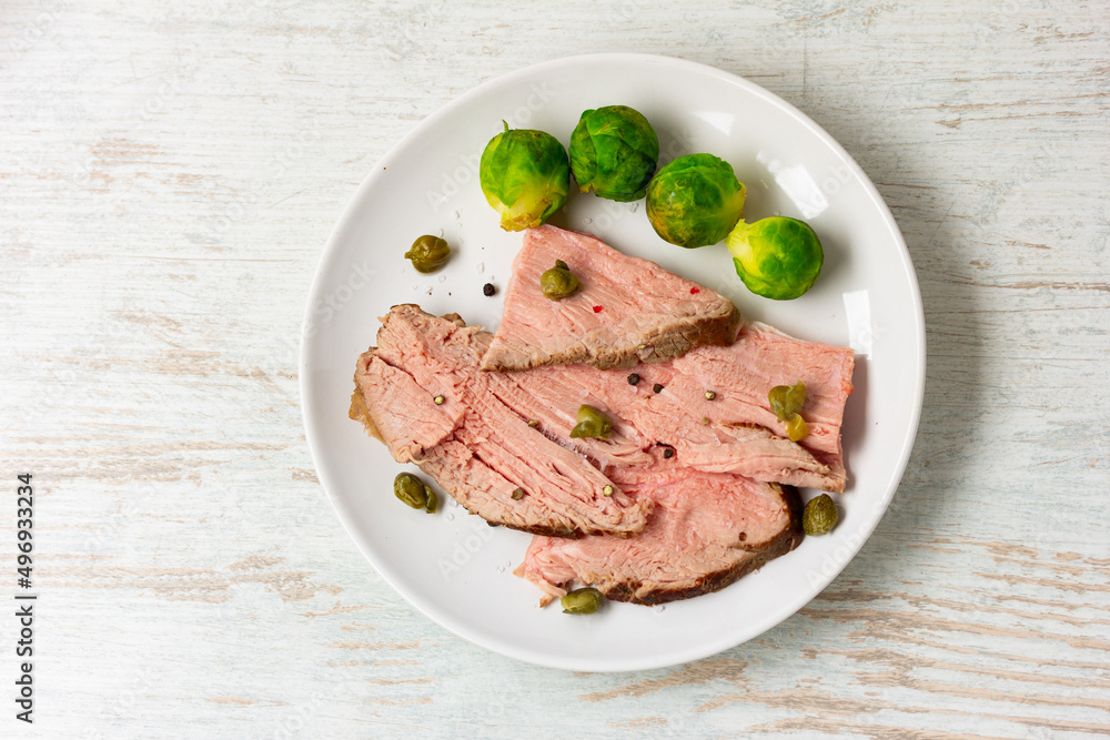 sliced roast beef on white ceramic plate sliced roast beef on white ceramic plate