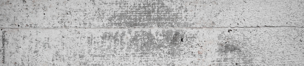 Light gray wall concrete surface background with scratches and cracks. High resolution grungy wall texture. Long panoramic banner.