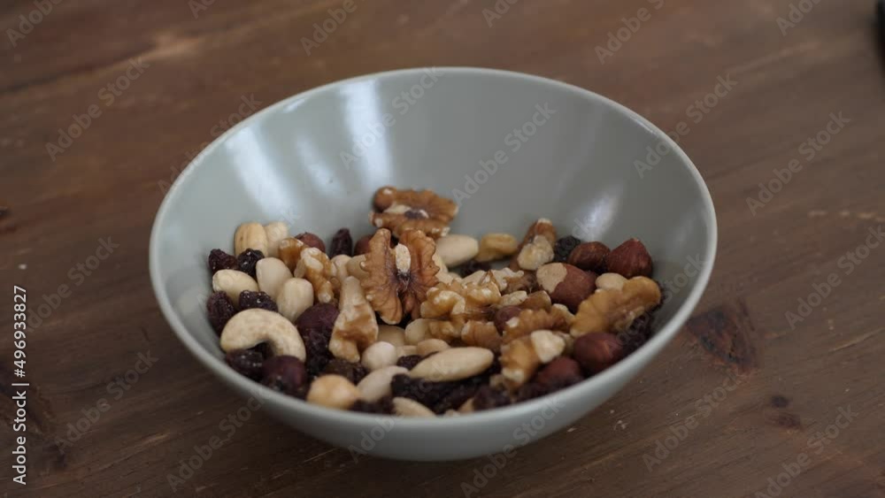 People taking healthy snacks from a bowl People taking healthy snacks from a bowl