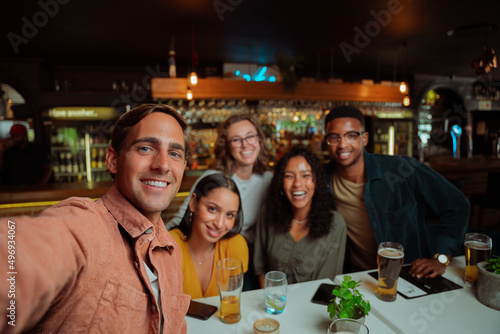 diverse group of friends going out for dinner taking selfie 