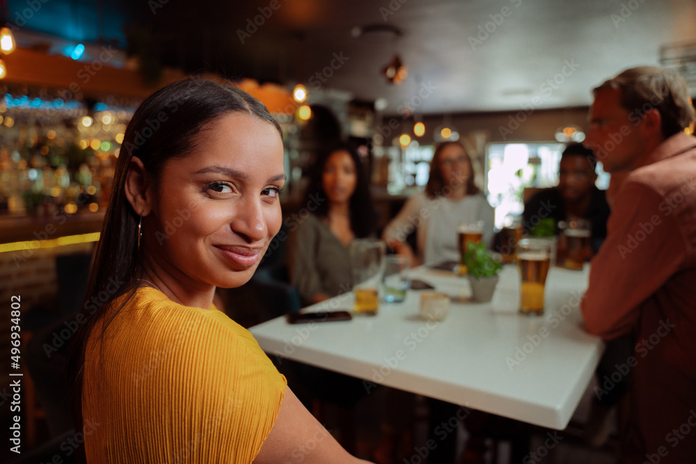 diverse women smiling while out for dinner with friends diverse women smiling while out for dinner with friends