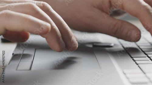 Close-up. Male hands work with the touchpad of a laptop. Input