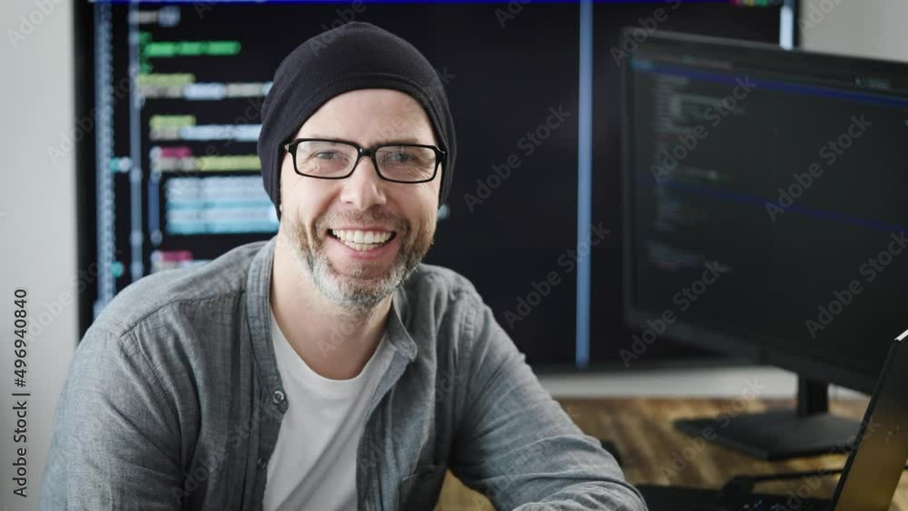 Portrait of an adult man in the workplace. The programmer smiles and looks into the camera. Positive and self-confident employee of the company. Portrait of an adult man in the workplace. The programmer smiles and looks into the camera. Positive and self-confident employee of the company.