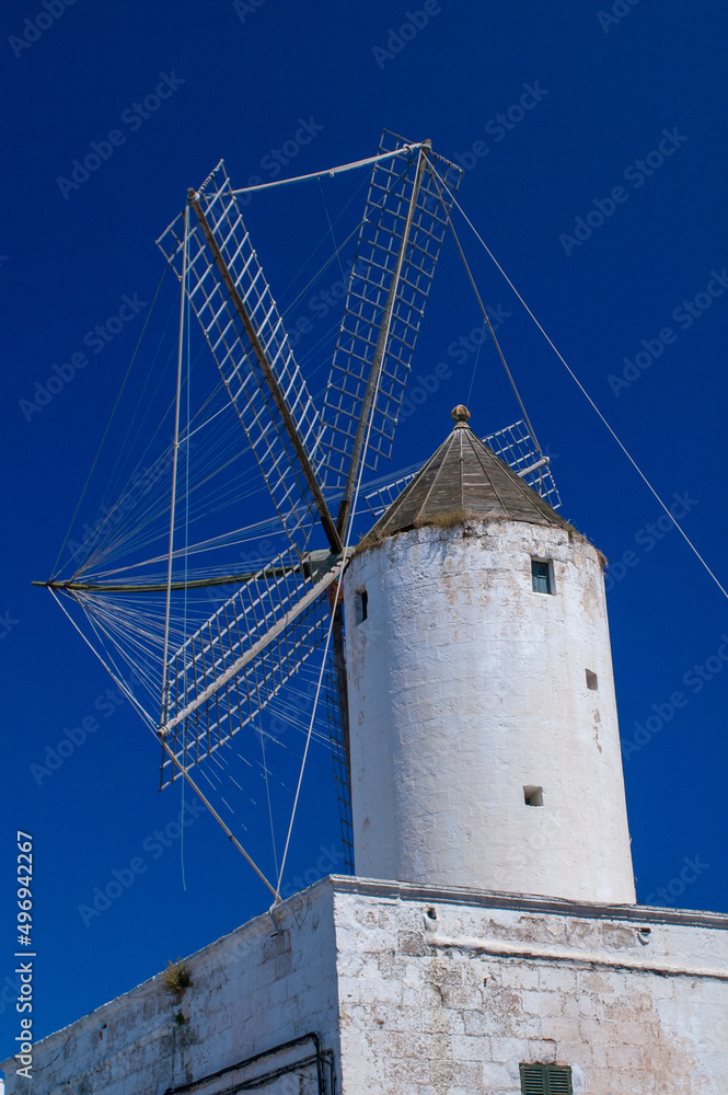 Old windmill in Menorca against blue sky