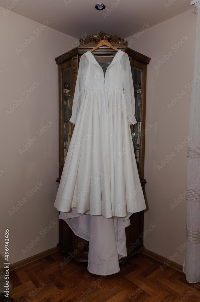 White dress of the bride on a hanger. Wedding White dress of the bride on a hanger. Wedding