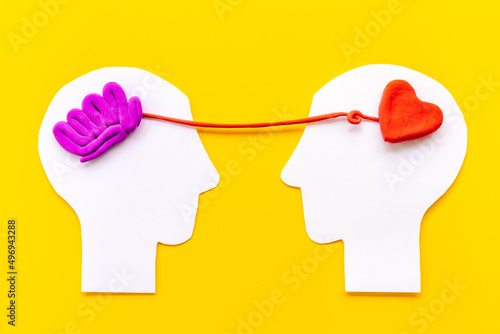 Brain and heart - logic and emotion. Communication between two paper human heads