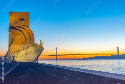 Sunrise view of Monument of the Discoveries in Belem and bridge of 25th April , Lisbon, Portugal photo