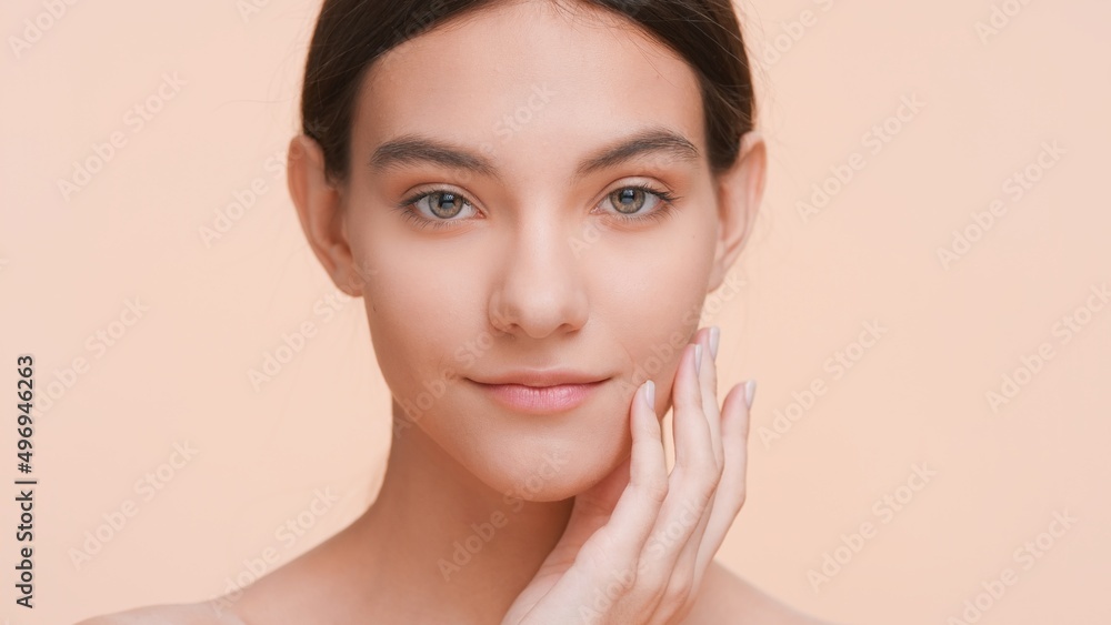 Close-up beauty portrait of young woman who gently lays her fingers on the jawline | Pure skin and skin care concept. Close-up beauty portrait of young woman who gently lays her fingers on the jawline | Pure skin and skin care concept.