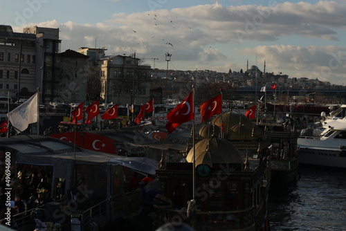 Fishing boats with waving Turkish flags with a magnificent view, eminönü photo