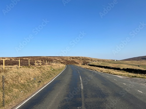 Looking along, School Lane, as it crosses the moors, on a late winters day near, Wycoller village, Lancashire, UK photo