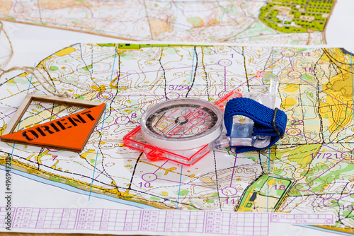 Sport orienteering. Symbols of the sport Topographic map  compass and prism with the inscription Orient