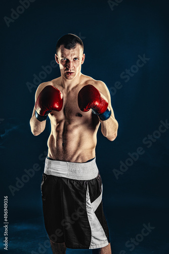 Sportsman boxer fighting on black background. Copy Space. Boxing sport concept