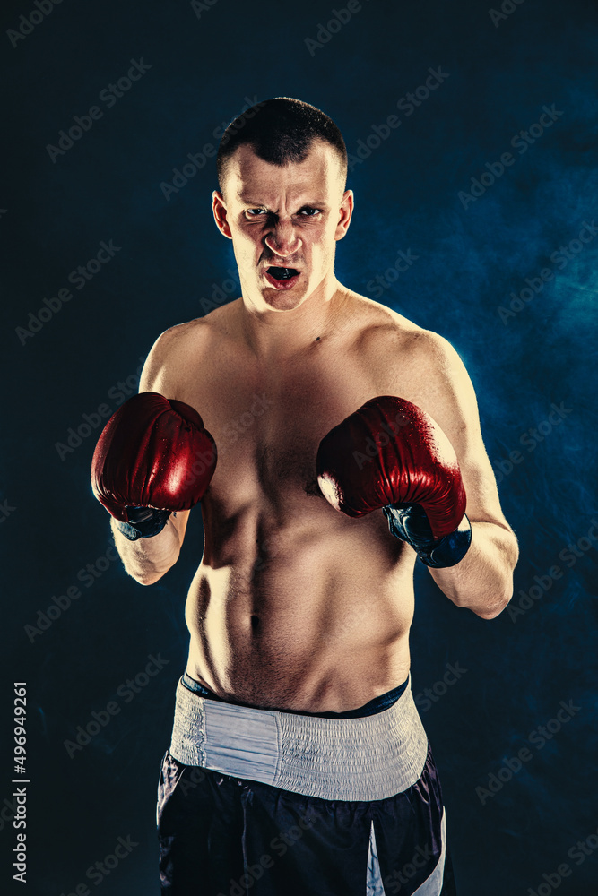 Sportsman boxer fighting on black background. Copy Space. Boxing sport concept