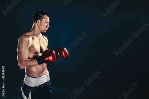 Sportsman boxer fighting on black background. Copy Space. Boxing sport concept © zamuruev