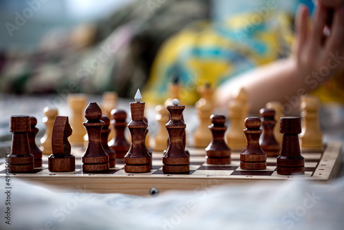 chess pieces on a wooden chessboard close-up